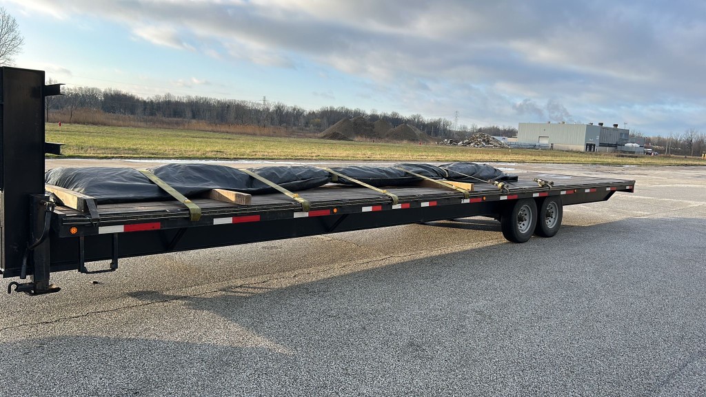 Red Shark Transport gooseneck with tarped hotshot load